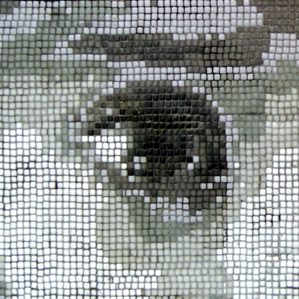 mosaic portrait of the eyes of a young Yezidi boy