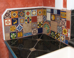 mexican tiles refelct on dark granite tiles to illustrate the Redfin blog